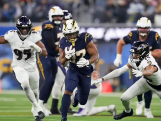 Los Angeles Chargers running back J.K. Dobbins (27) breaks past Baltimore Ravens safety Kyle Hamilton (14) during the first half of an NFL game on Monday, Nov. 25, 2024, in Inglewood, Calif. (AP Photo/Eric Thayer)